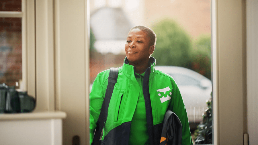 An OVO Boiler Engineer stands at the front door