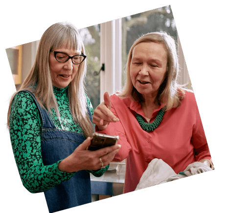 Two women looking at a smartphone 