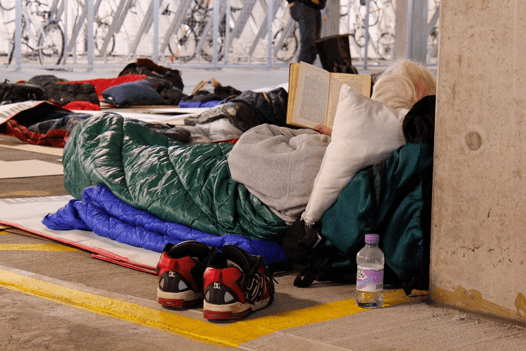 Man reading book Sleepout Bristol 2015 OVO Energy 1625ip