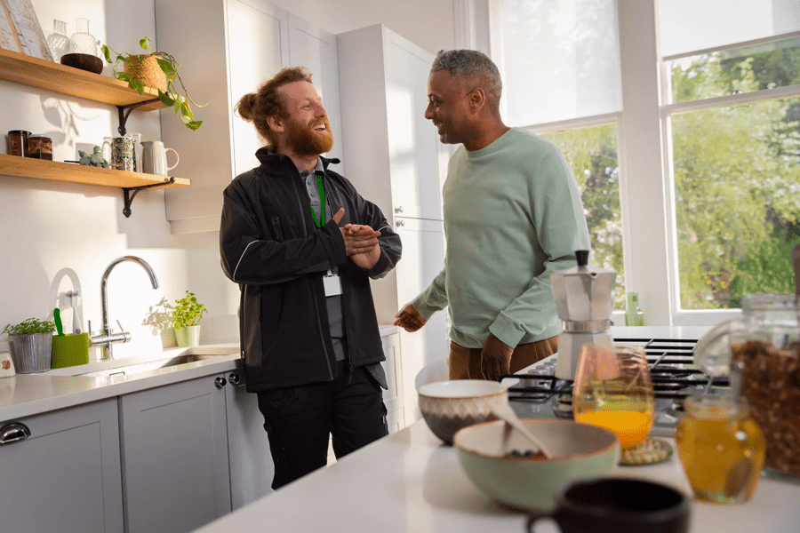 Boiler repair engineer chatting to a customer