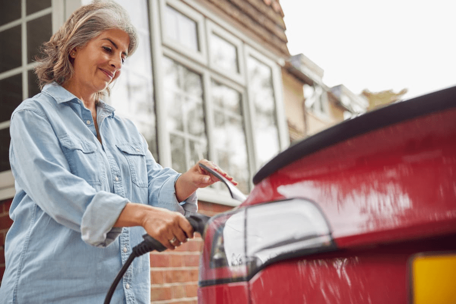 woman charging an electric car