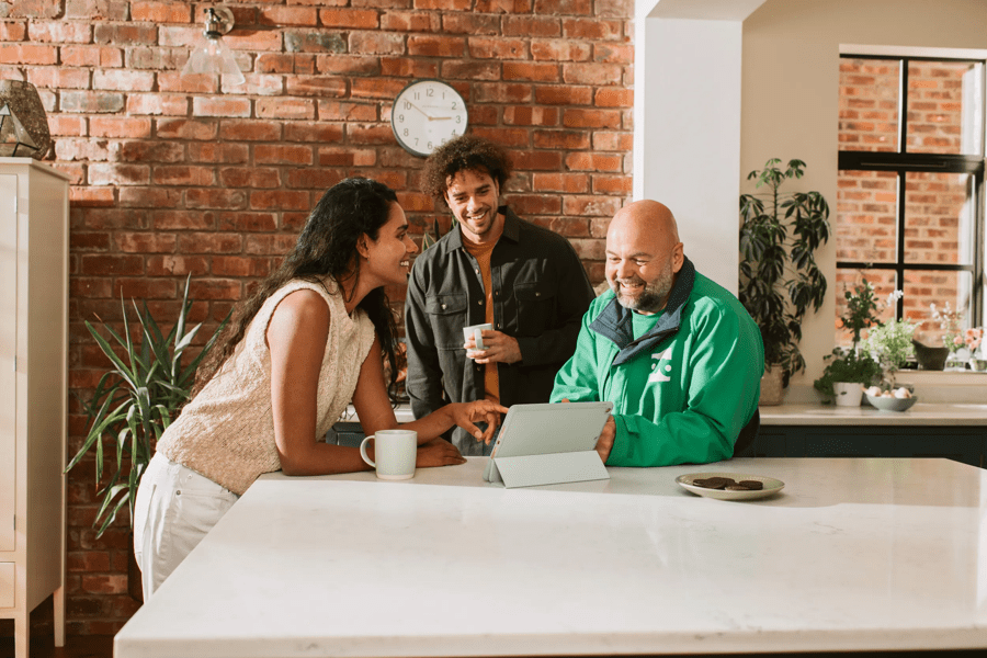 OVO engineer and customers in kitchen smiling