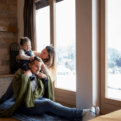 A father, mother and daughter staying warm at home in the winter