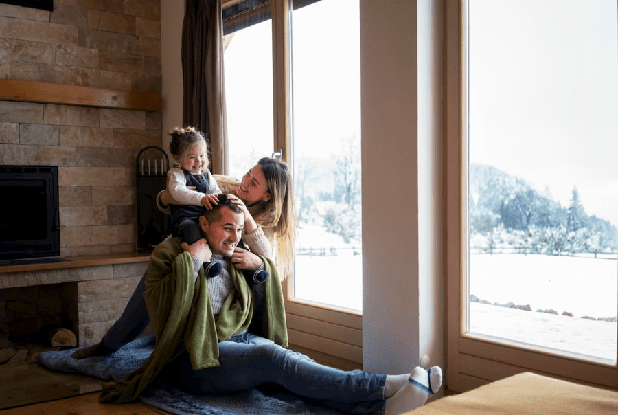 A family staying indoors while it snows outside