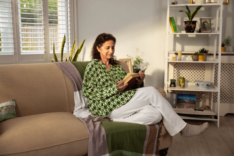 Woman reading a book on the sofa