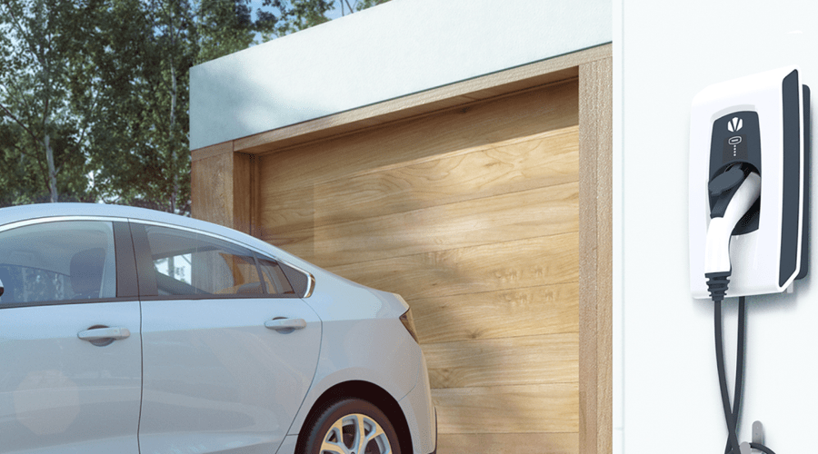 An EV charger mounted next to the garage