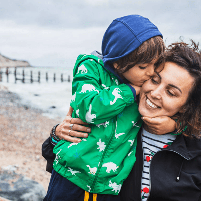  Woman and child hugging on a beach