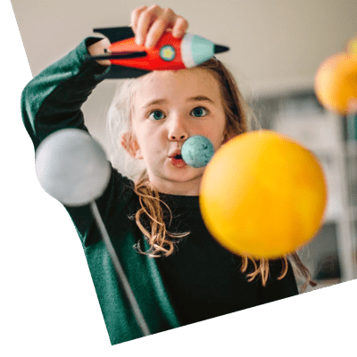 Girl playing with a toy rocket