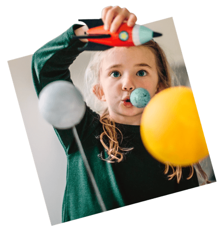 Little girl playing with homemade planetarium