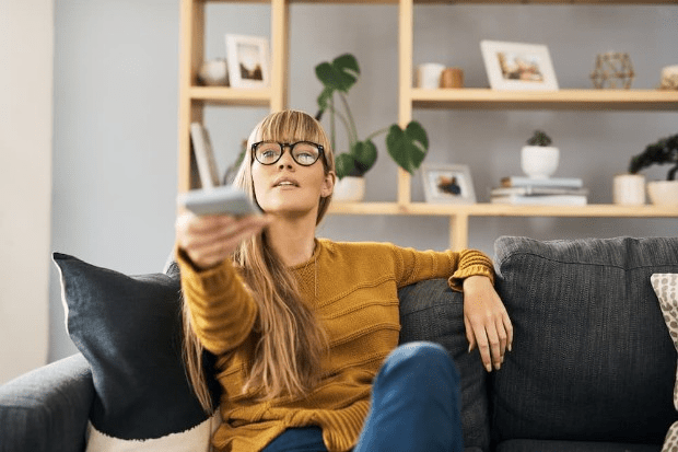 Woman watching TV at home