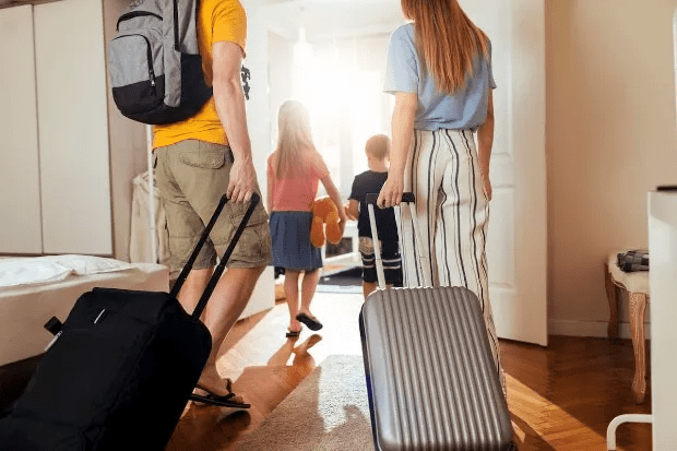 family going on holiday with luggage suitcases