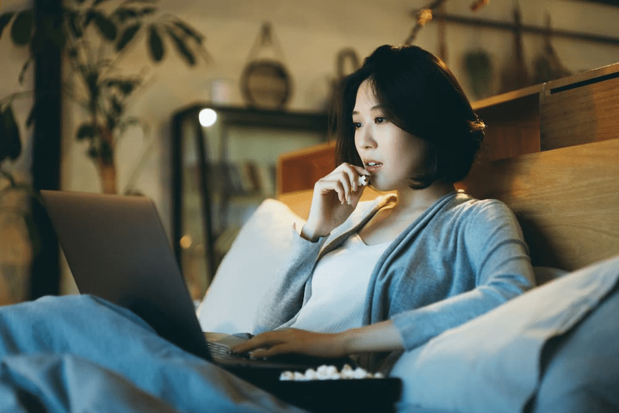 A woman watching a film on her laptop