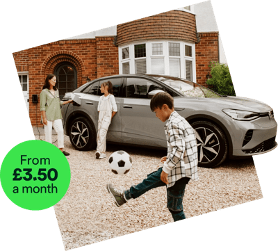 Family outside house with electric car