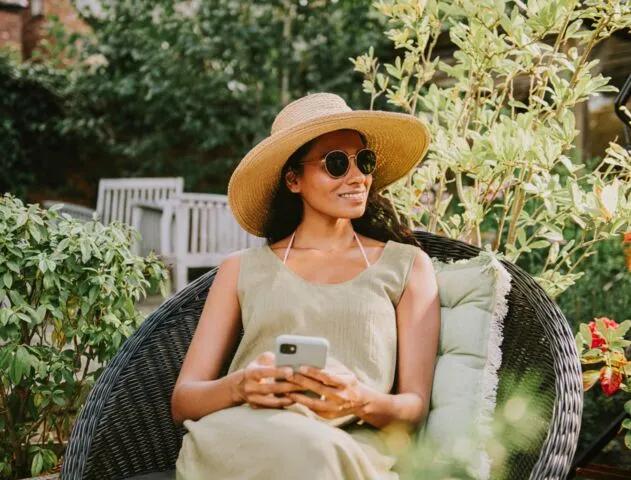 Woman looking at phone in garden