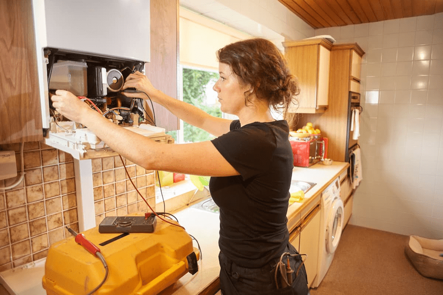An engineer repairing a gas boiler