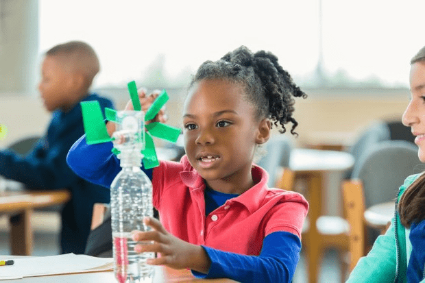 A child making a model wind turbine