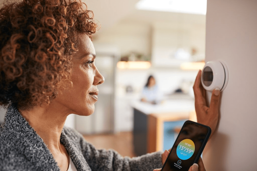 woman with a smart thermostat