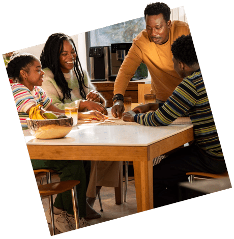 Family gathered around a kitchen table