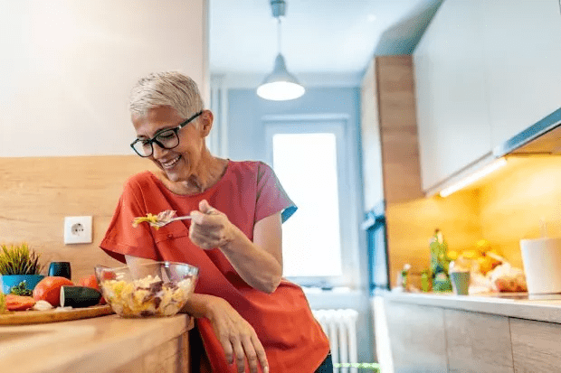 Middle-aged woman eating at home