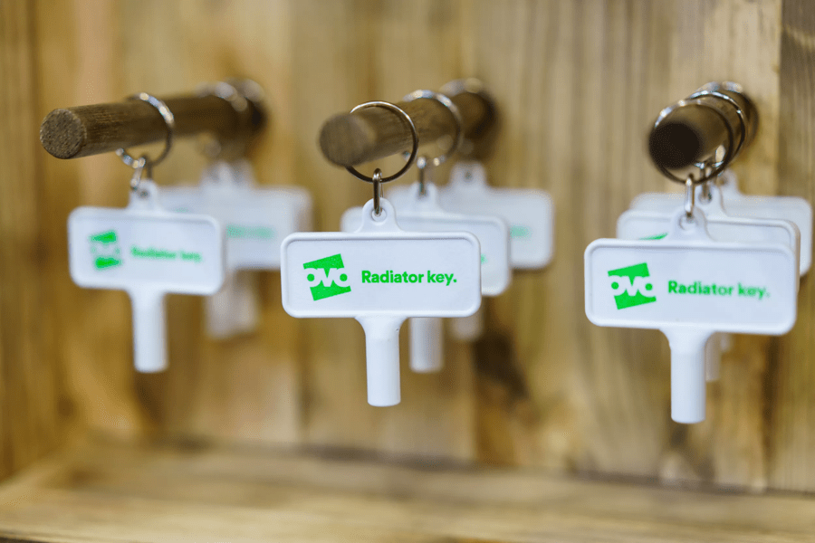 A row of OVO-branded radiator keys hanging on hooks