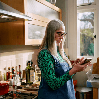 woman on phone in kitchen