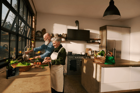 Couple washing dishes in kitchen