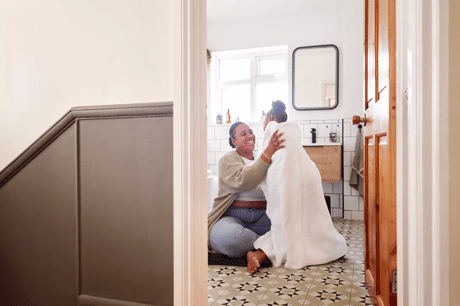 Mother wrapping child in a bath towel