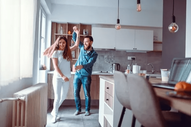 Couple dancing near their radiator in the kitchen