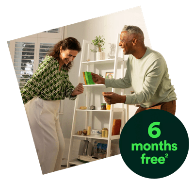 Smiling couple dancing at home – image has a circular banner saying '6 months free'