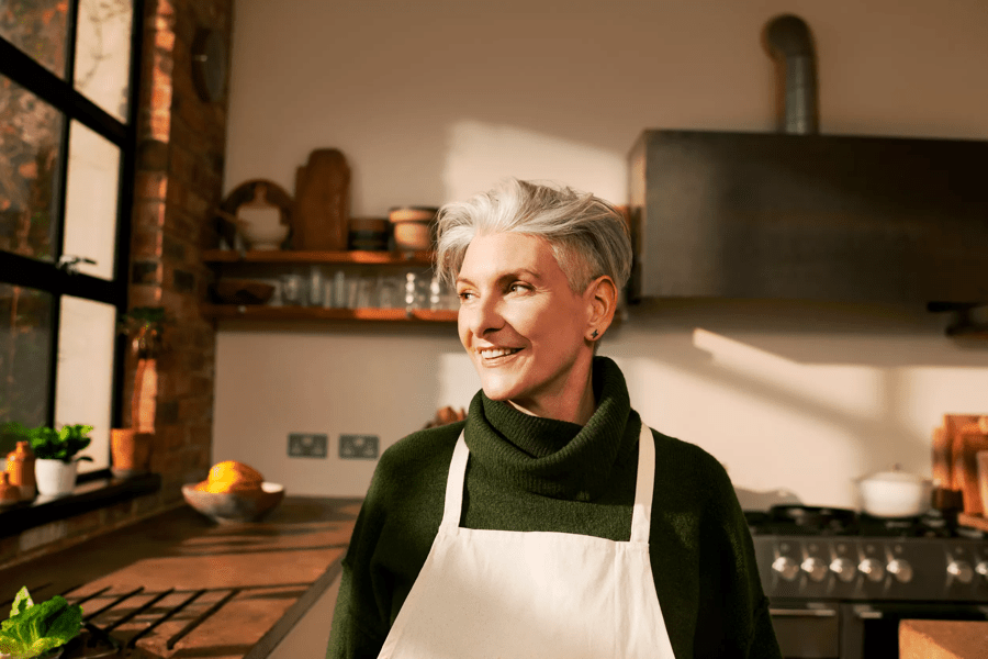 woman smiling in a kitchen