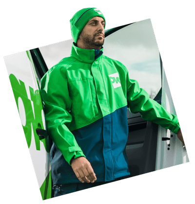 An OVO Energy employee wearing a boiler suit exits a white van