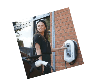 Woman plugging in car to charge