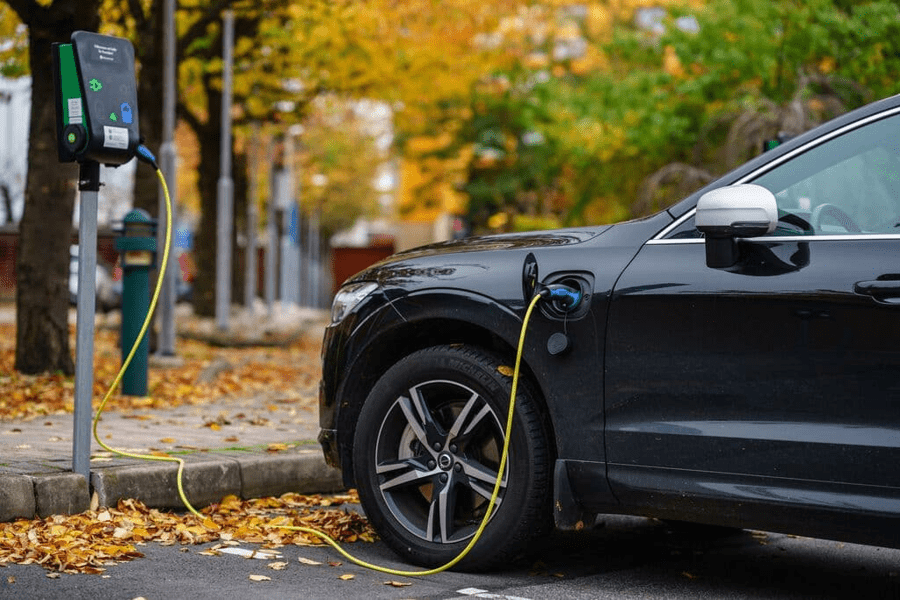 Volvo car plugged in for charging on street parking