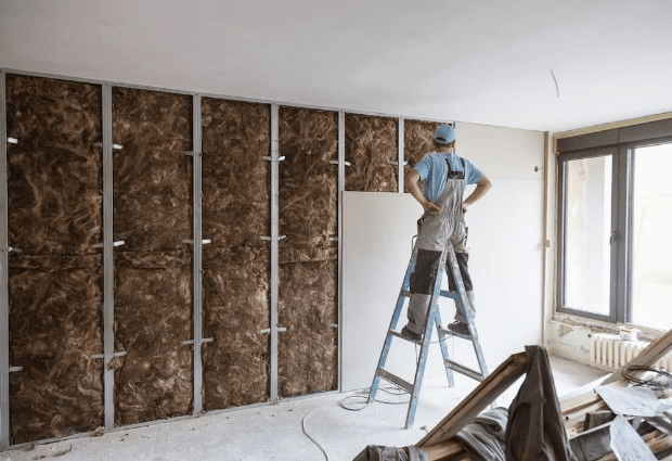 Man installing insulation