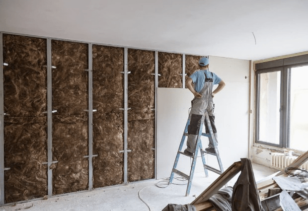 man insulating wall