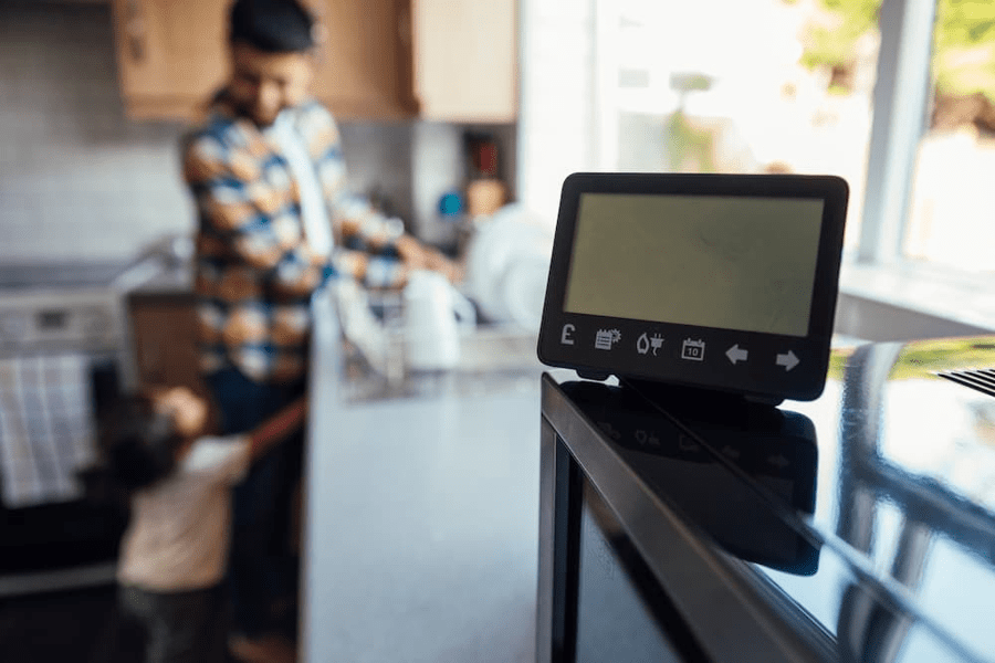 An In-Home Display in the kitchen with family in the background