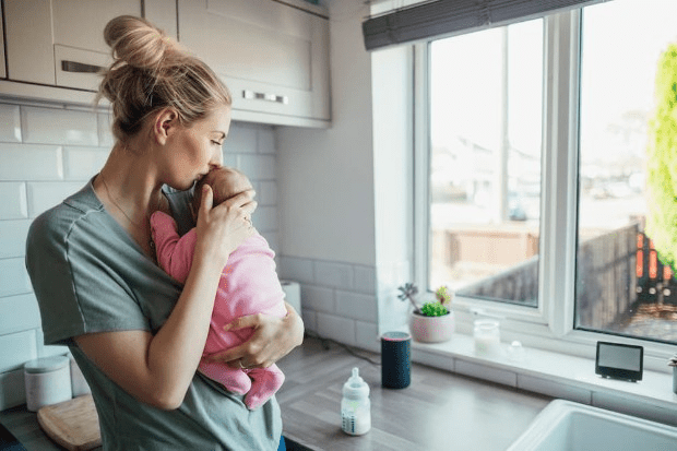 A mum and baby in the kitchen with their smart meter