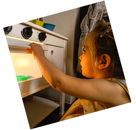 child playing with toy kitchen