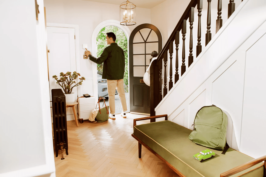 man walking out of door