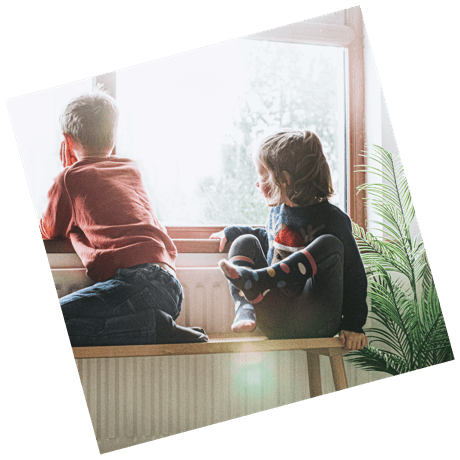 two children looking out of a window