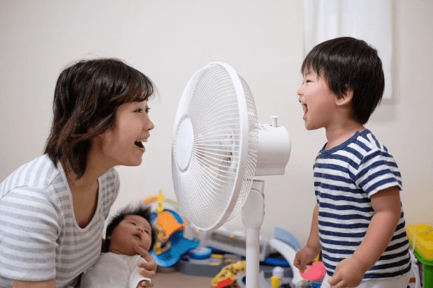 Mum and children with fan